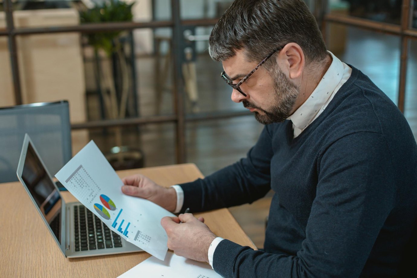 Business analyst reviewing PR Newswire pricing and alternatives comparison